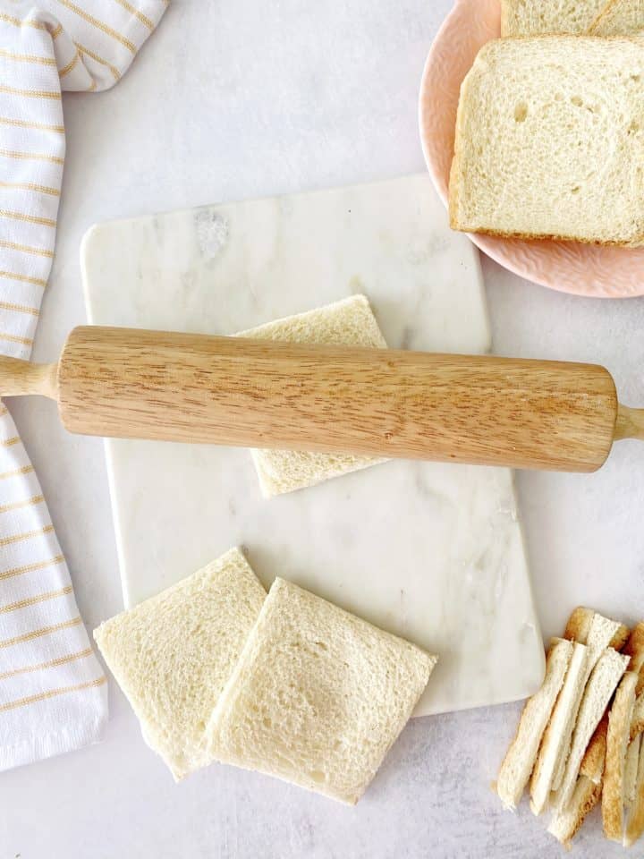 rolling pin on top of bread and bread slices arond 