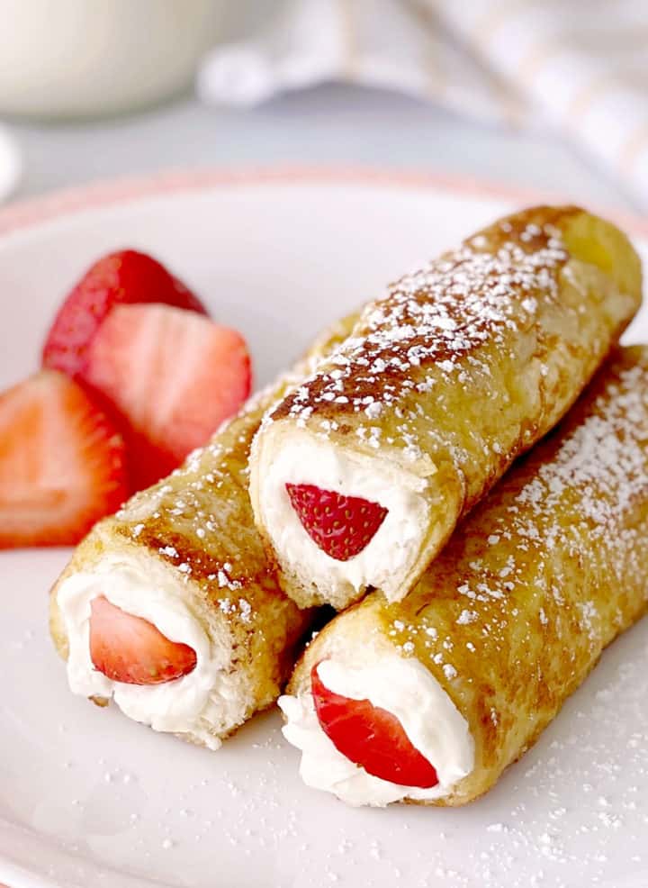 close up of strawberry rollups on a plate 