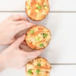 three chicken pot pies with kids hands holding one
