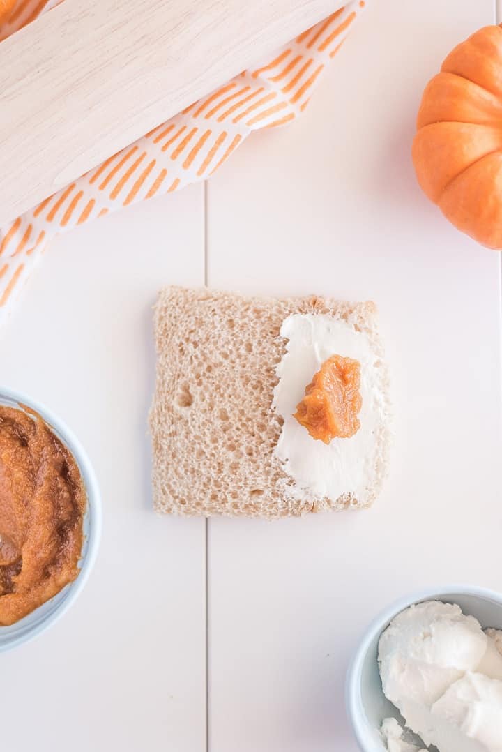 Bread, cream cheese, and pumpkin puree with orange towel