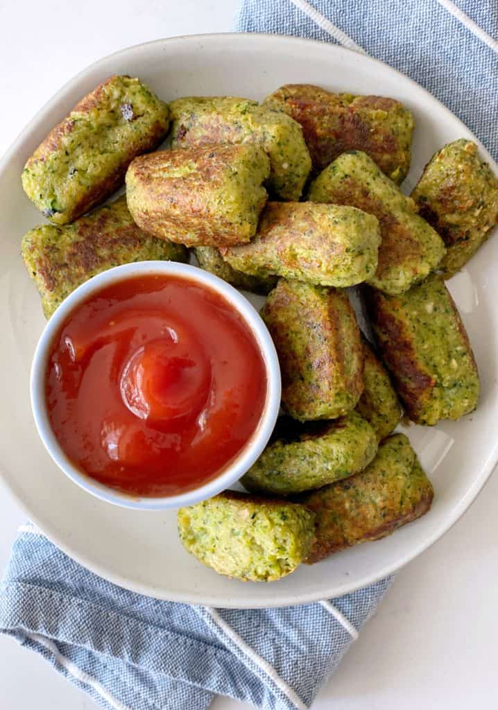 broccoli tater tots on a plate with ketchup dipping 