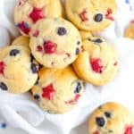 Several berry muffins on a white background with star confetti