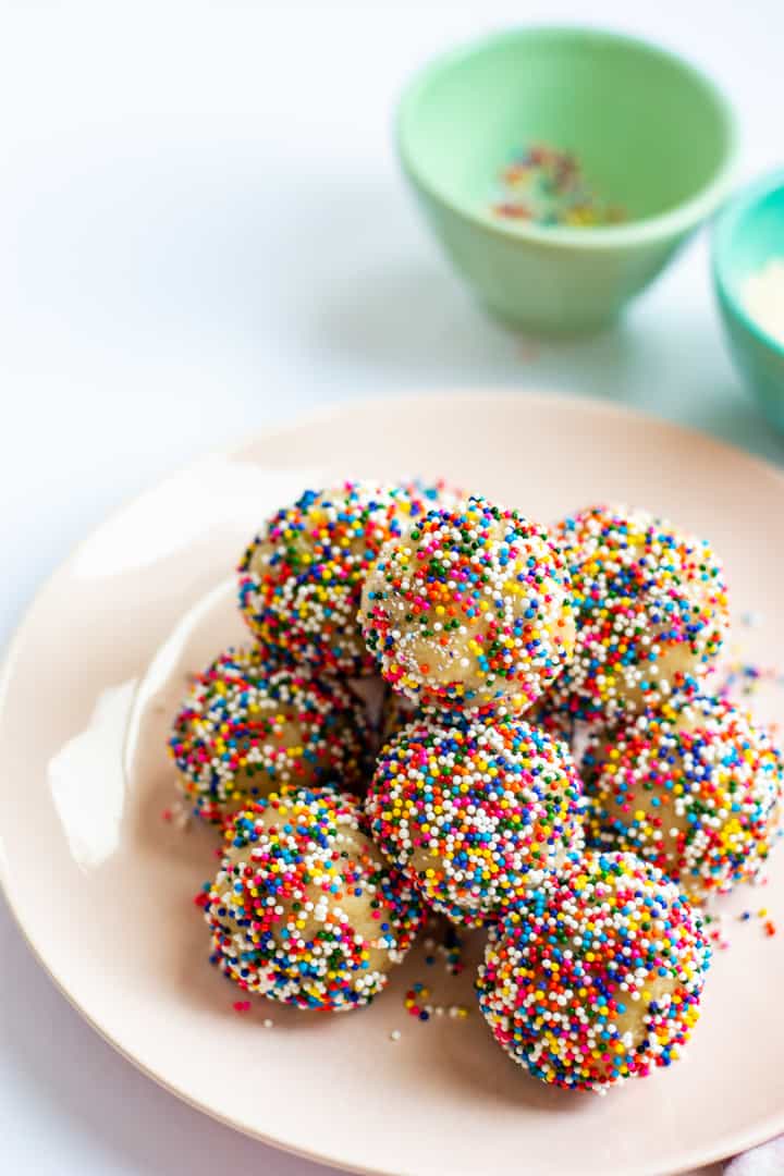 no bake cookie balls on a plate with sprinkles 