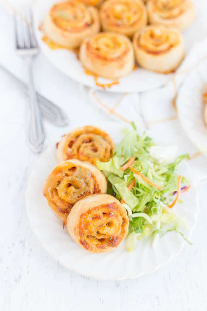 Pinwheels served with side salad on a plate 