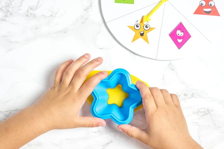 Hands molding playdoh star