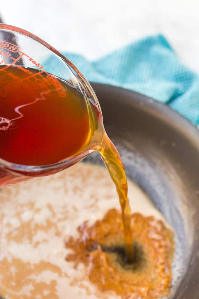 close up of pouring of beef broth 