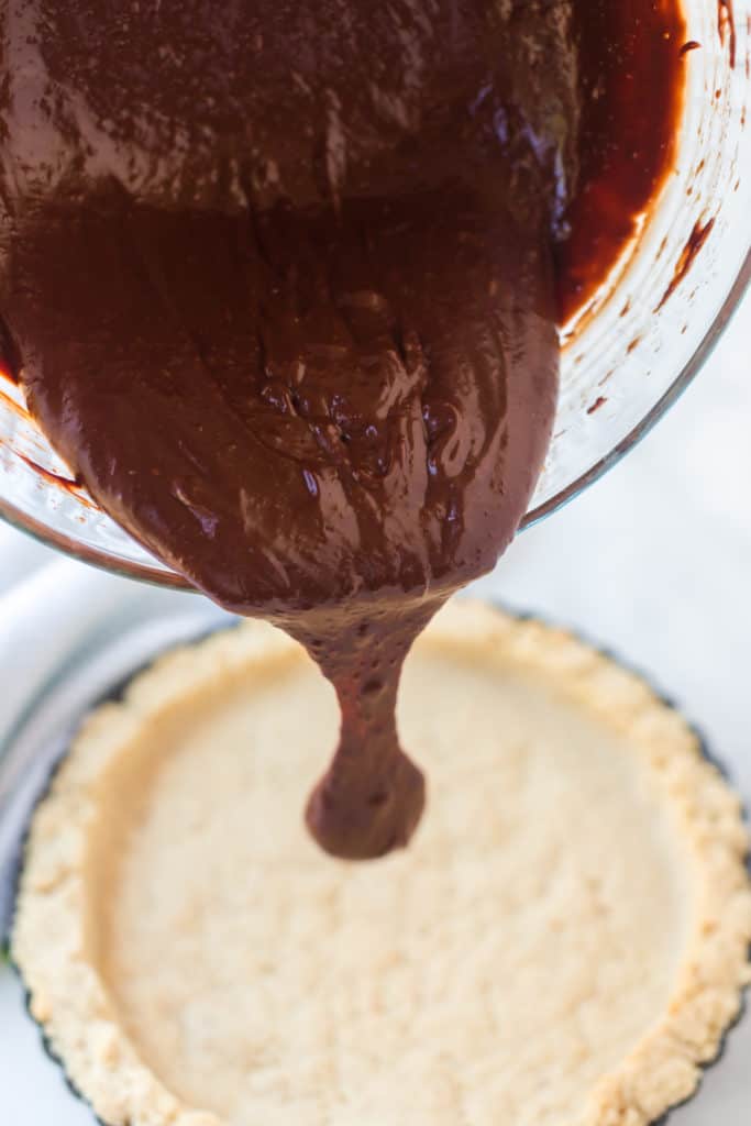 Chocolate being poured in pie crust 