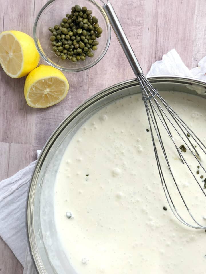 Pan of heavy cream with capers and lemons 