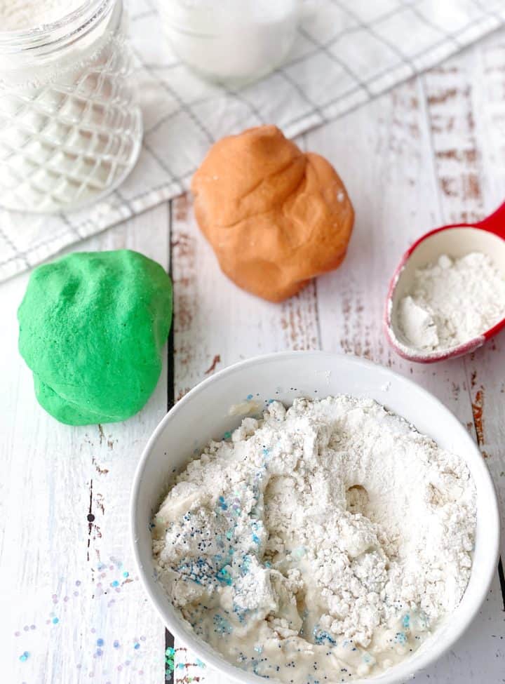 Homemade playdough bunches next to flour