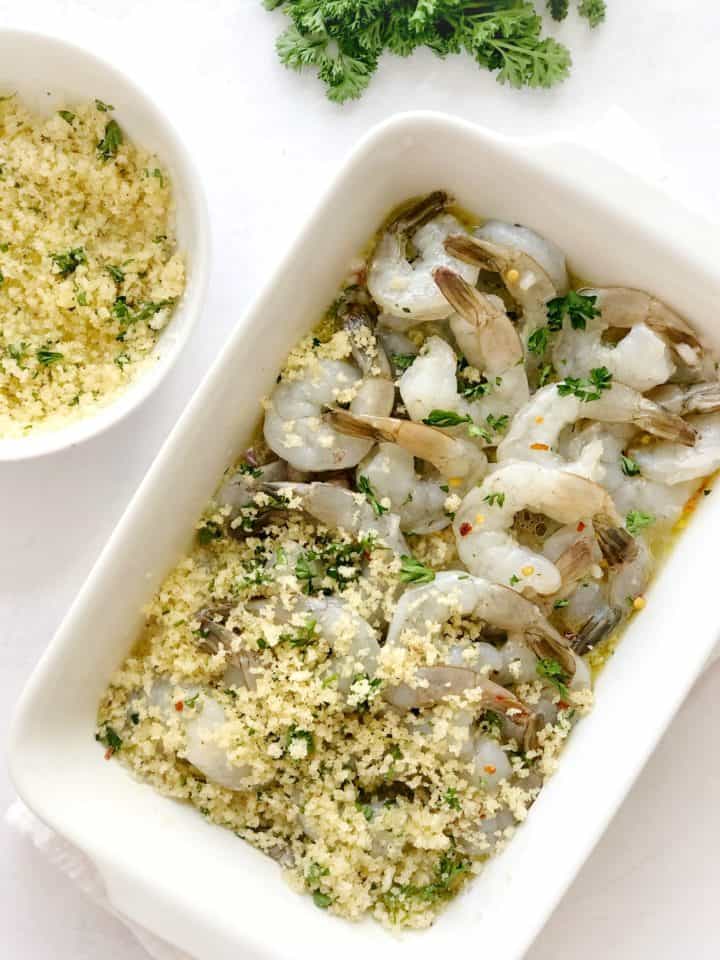 shrimp in a baking dish with panko mixture 