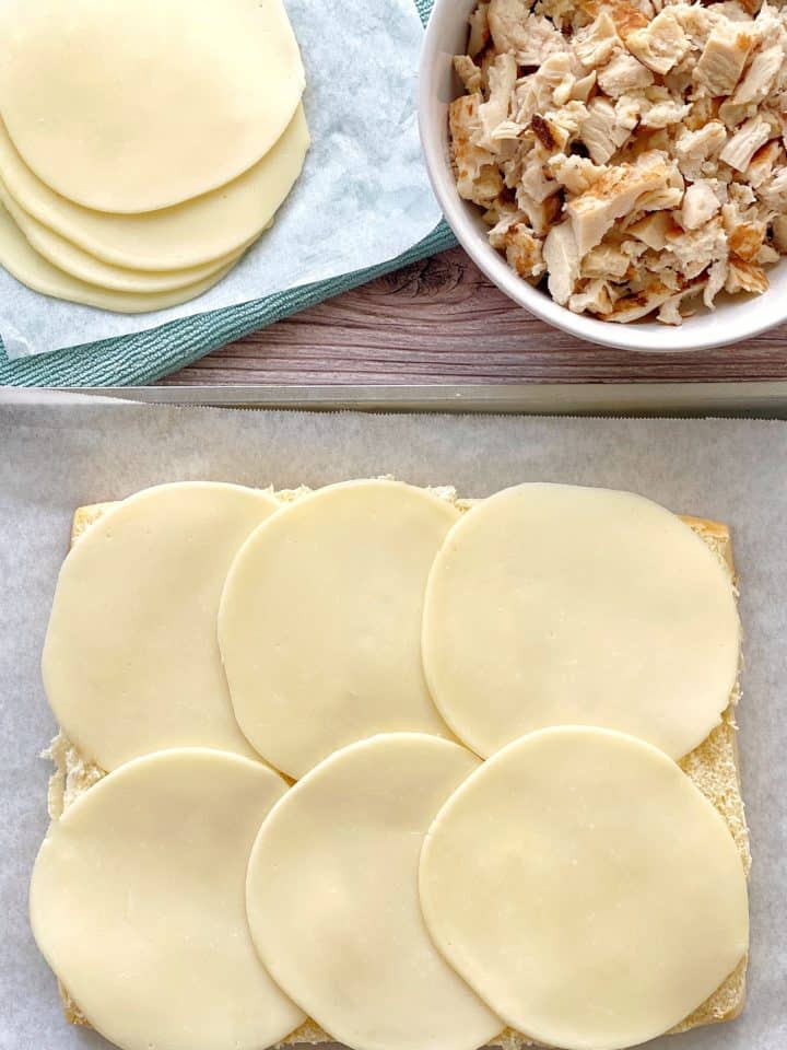 provolone cheese on top of Hawaiian rolls 