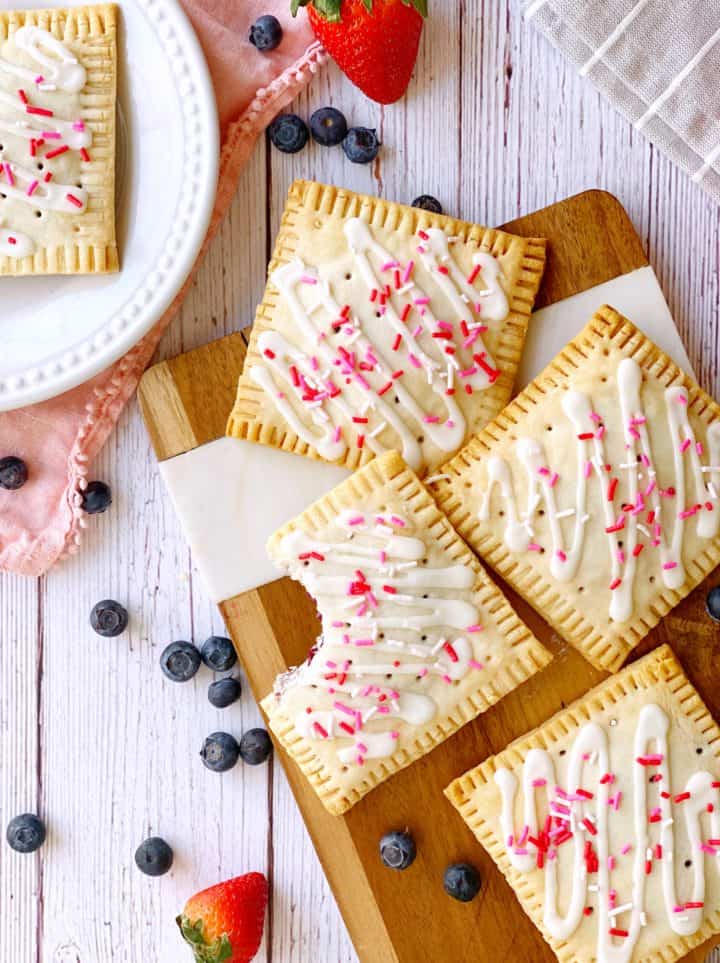 Pop tarts on a cutting board next to berries 