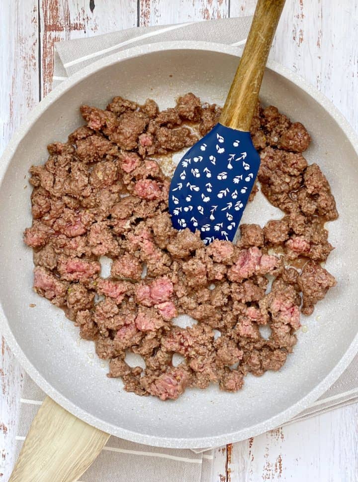 Ground beef in a pan and spatula 