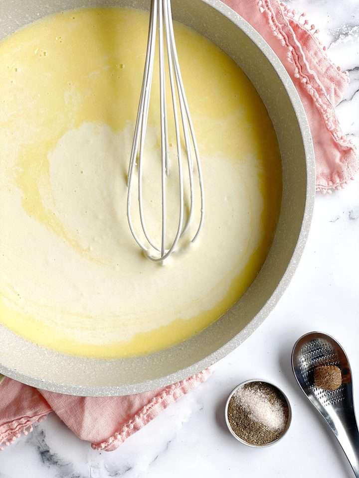 butter and cream mixed with a whisk on a pan 