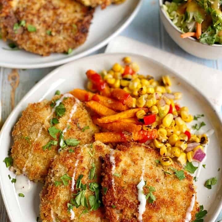 Beef Malanesa on plate with sewet potatoes and corn