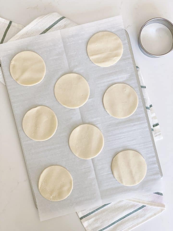 dough in circles on a baking sheet with parchment paper