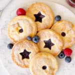 berry pies with stars in the middle and berries around it