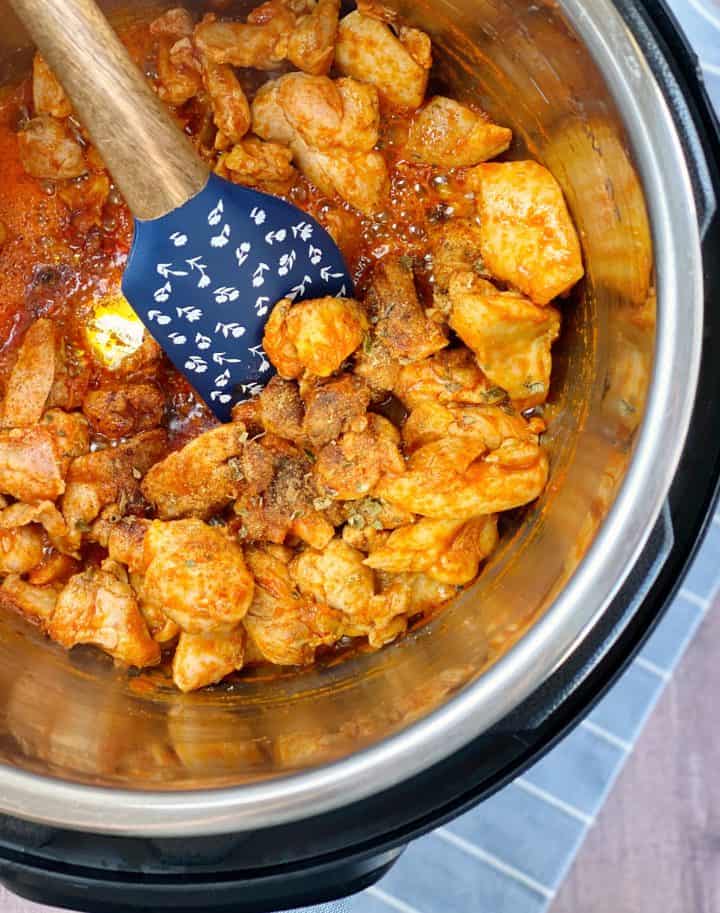 cooked chicken with spices in a pressure cooker 