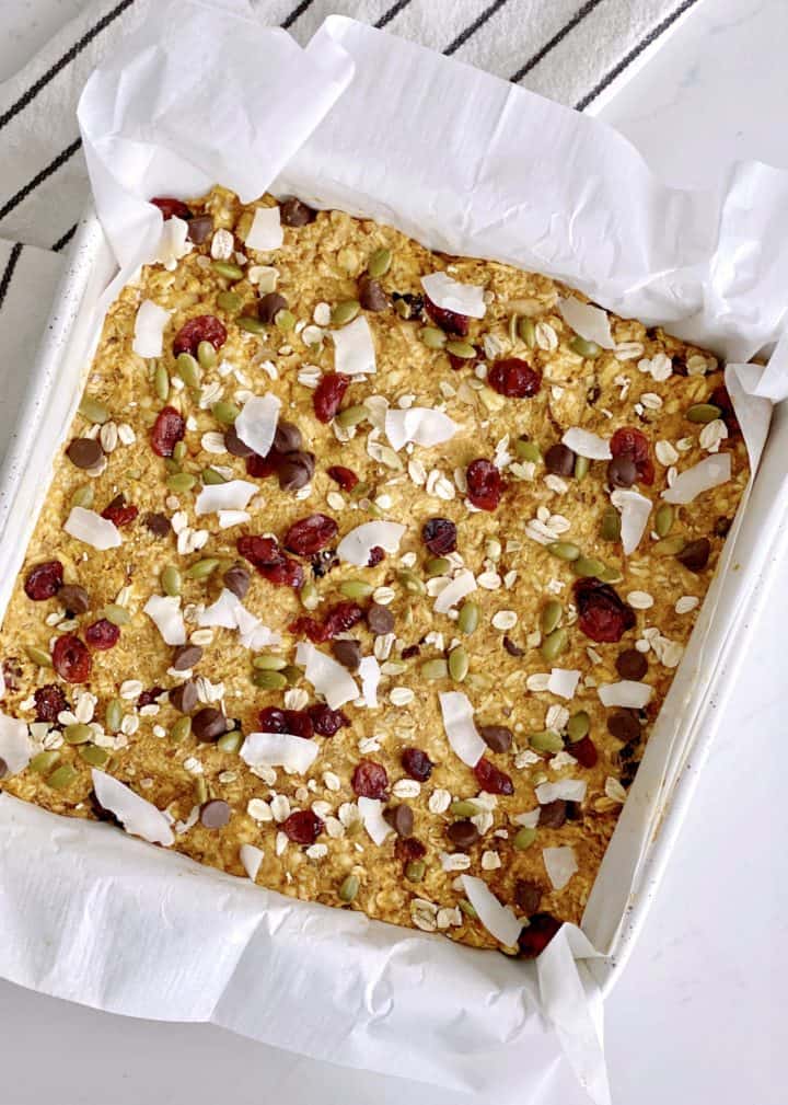 pan filled with breakfast bars mixture and parchment paper for pumpkin oatmeal bars 