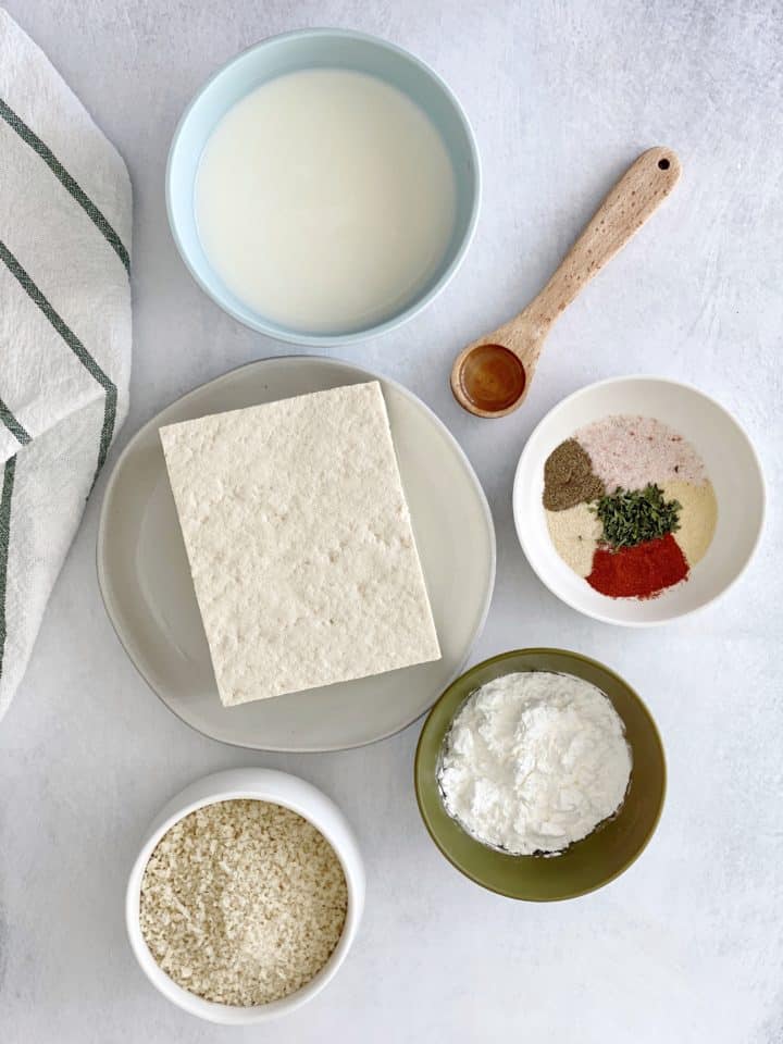 flatlay of ingredients including tofu, seasonings, cornstarch, milk and tofu 