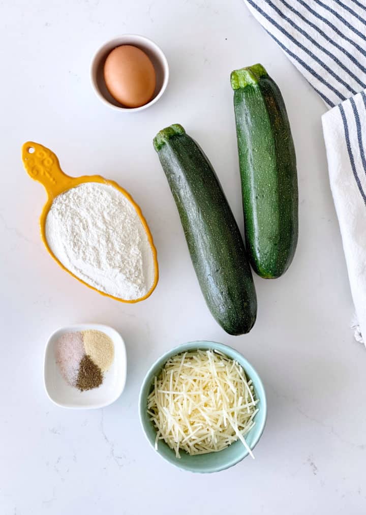 two zucchinis, flour, seasonings, and parmesan cheese