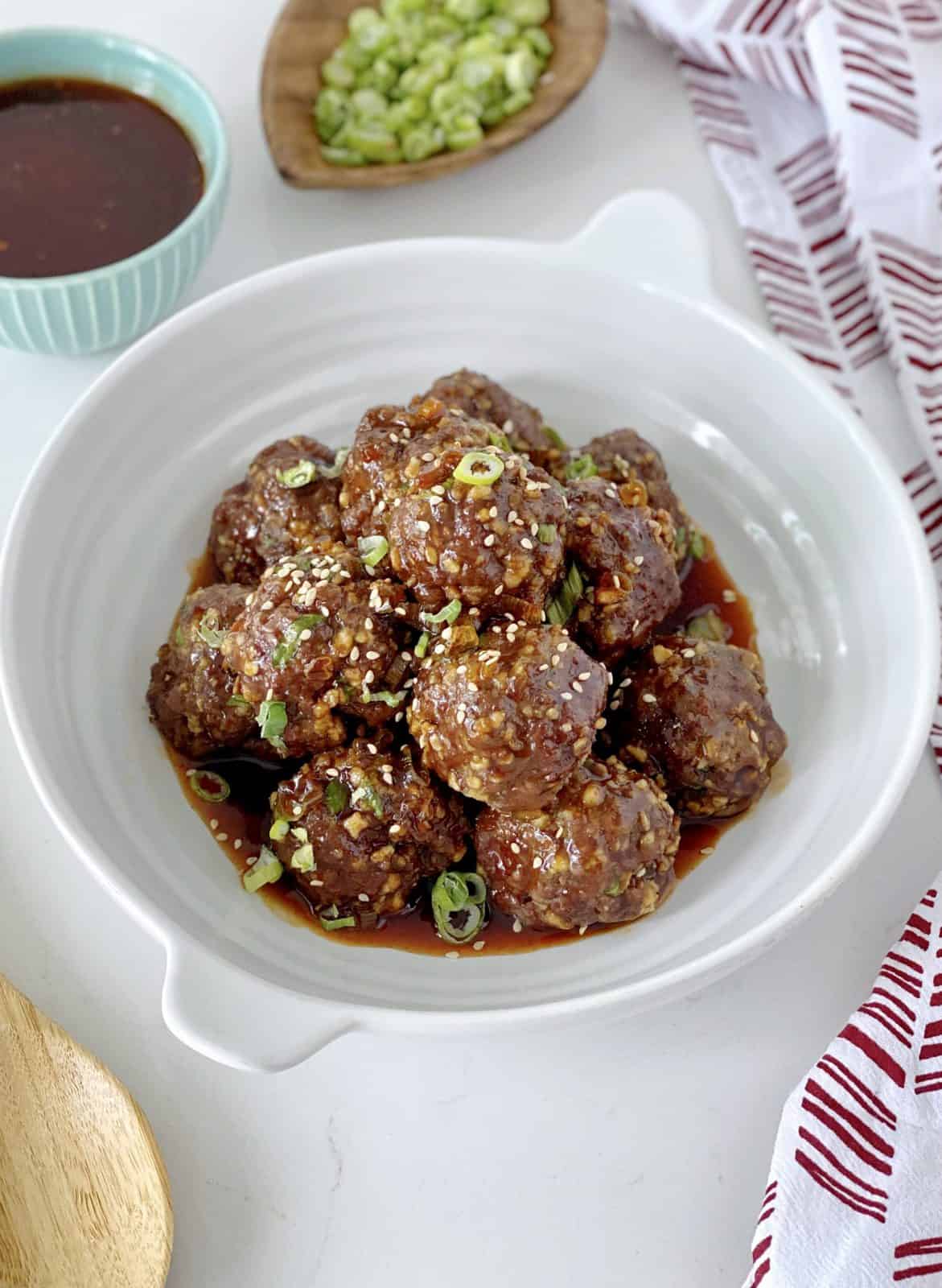 bowl of meatballs coated with sauce 