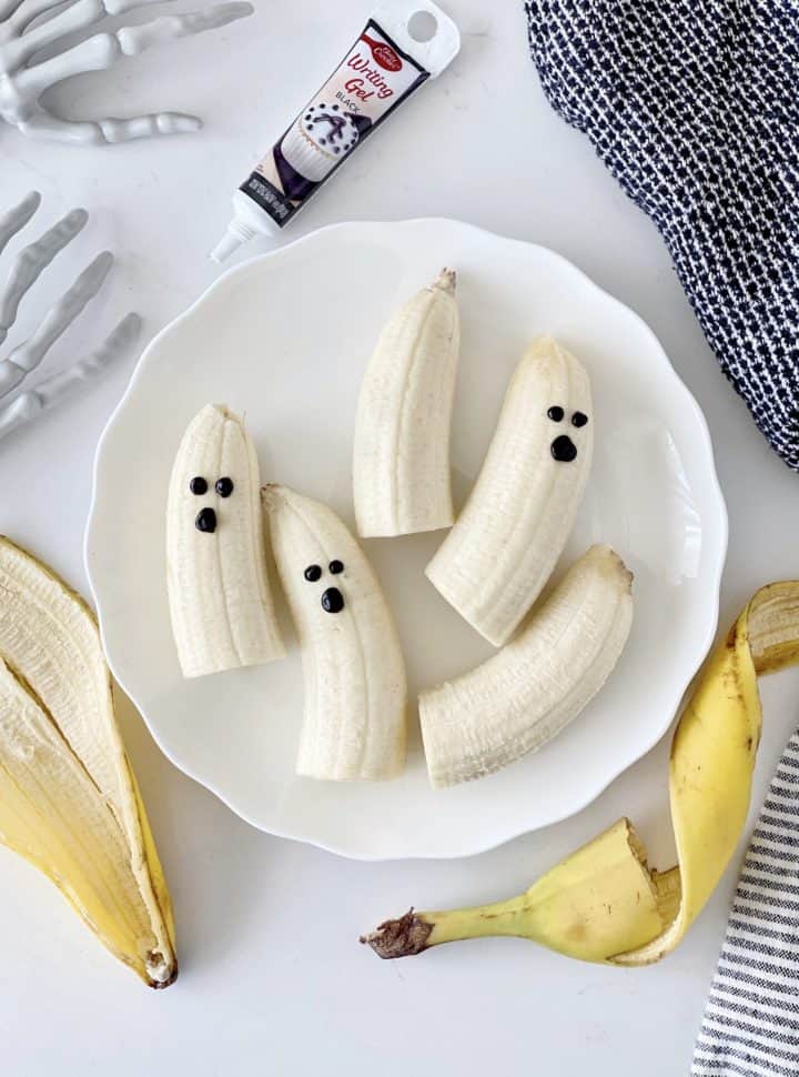 banana ghosts on a plate with banana peels 