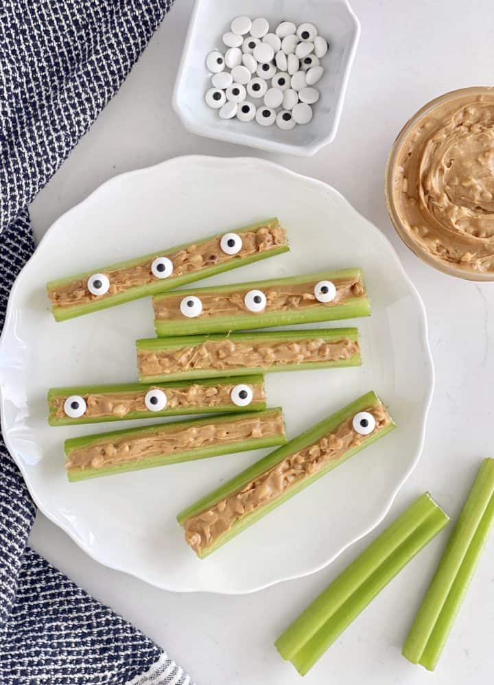 celery stalks with peanut butter and candy eyes on them 