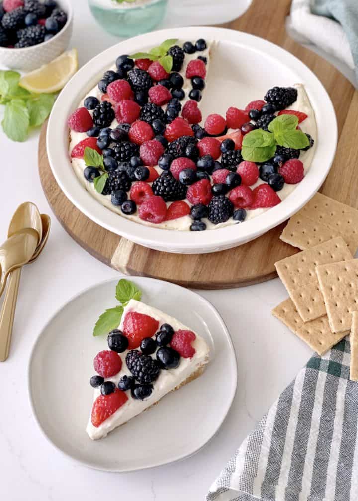 cheesecake with one slice cut and a cut cake on a plate 
