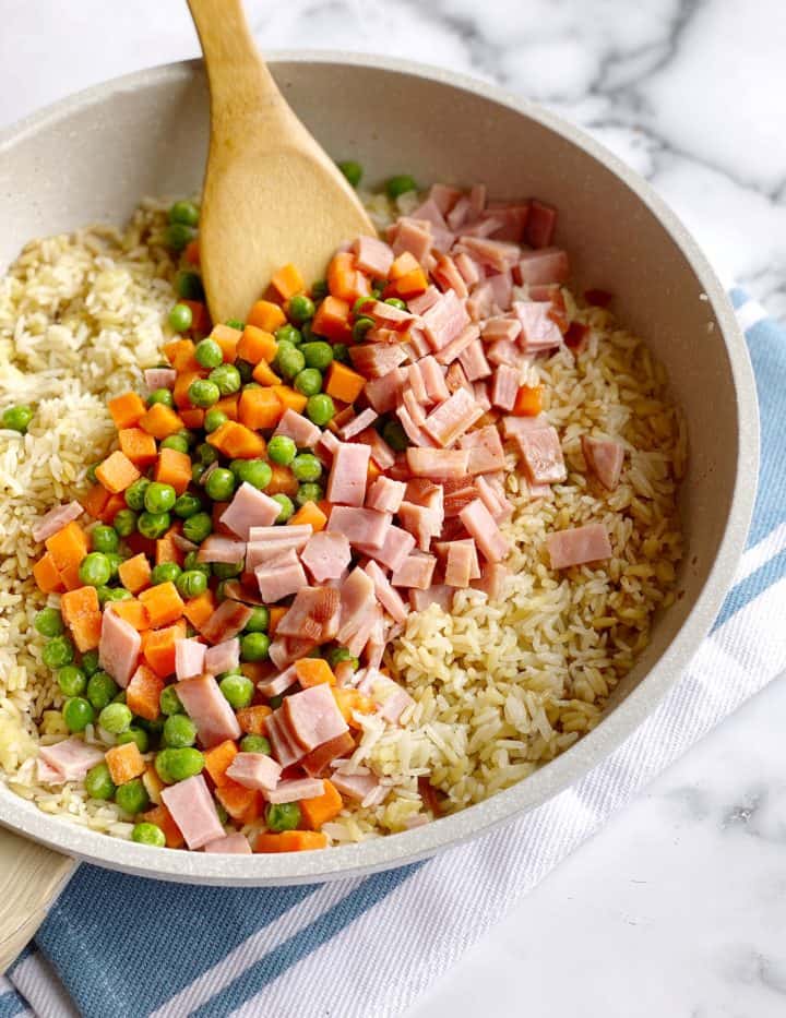 plate full of ham and mixed vegetables and rice 