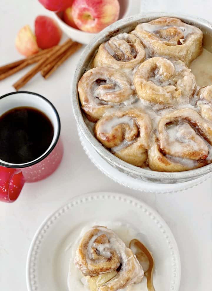 over the top shot of coffee cinammon rolls serving plate and cinnamon roll on plate
