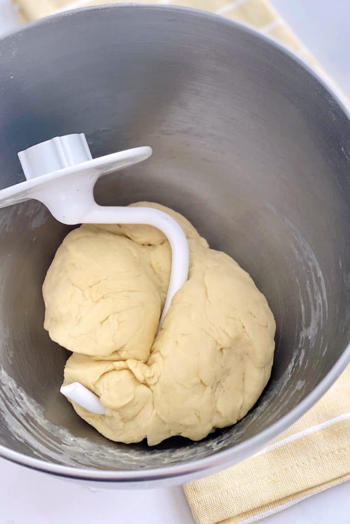 kneaded dough ball and a dough hook in it 