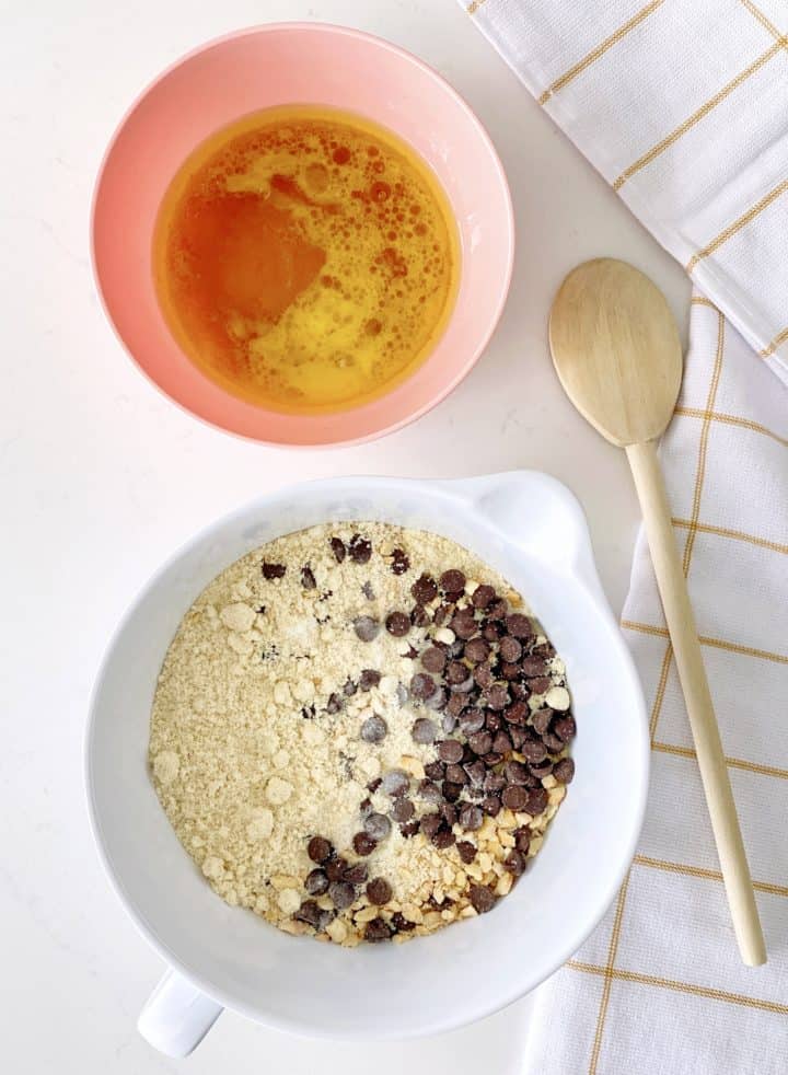 bowl of dry ingredients and a bowl with egg and honey 