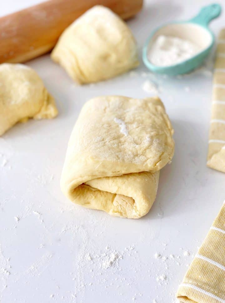 rolled dough next to other dough pieces 