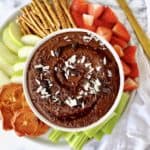 chocolate hummus with pretzels and fruit on a platter
