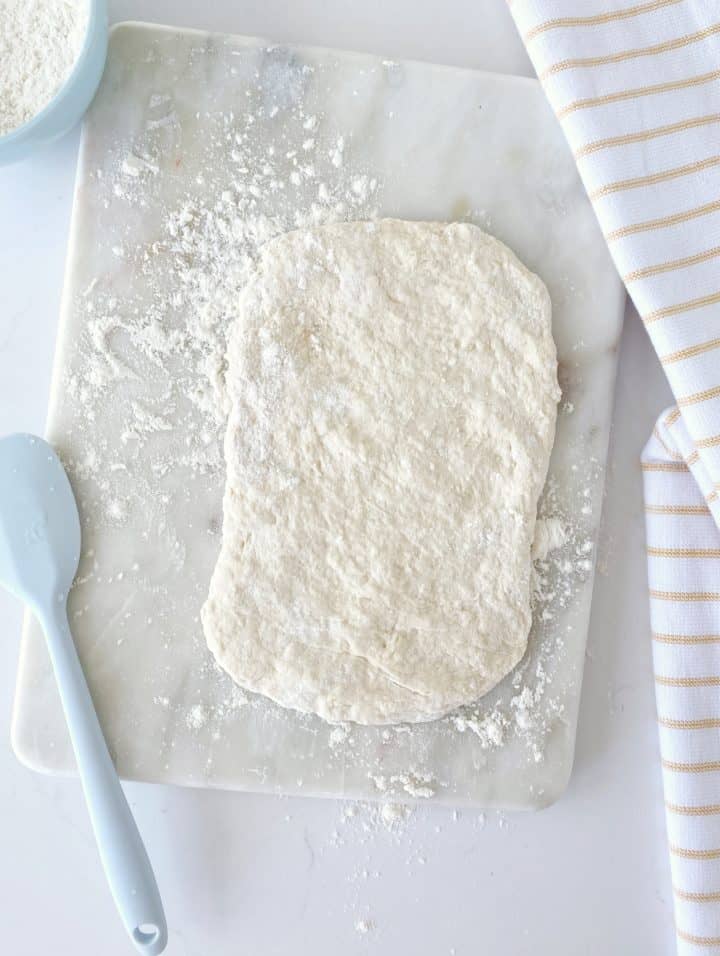 rectangular shaped dough on floured surface 