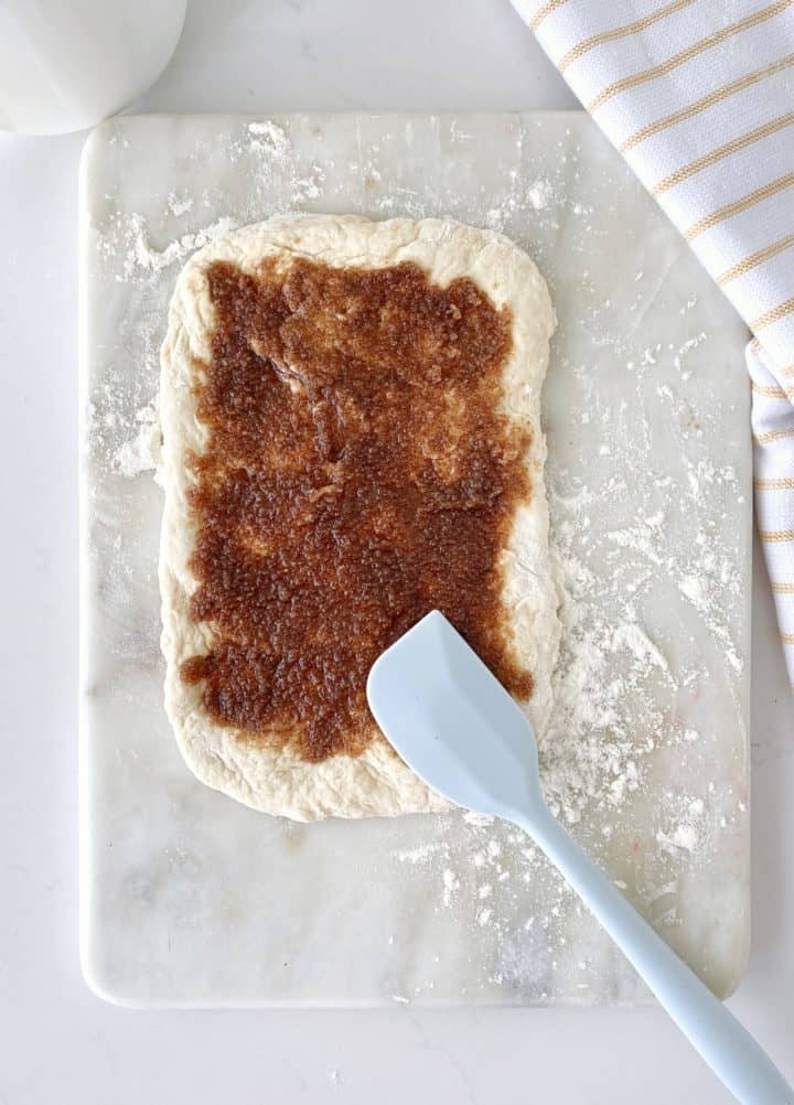 rectangle flour with brown sugar mixture on top and a spaturla 