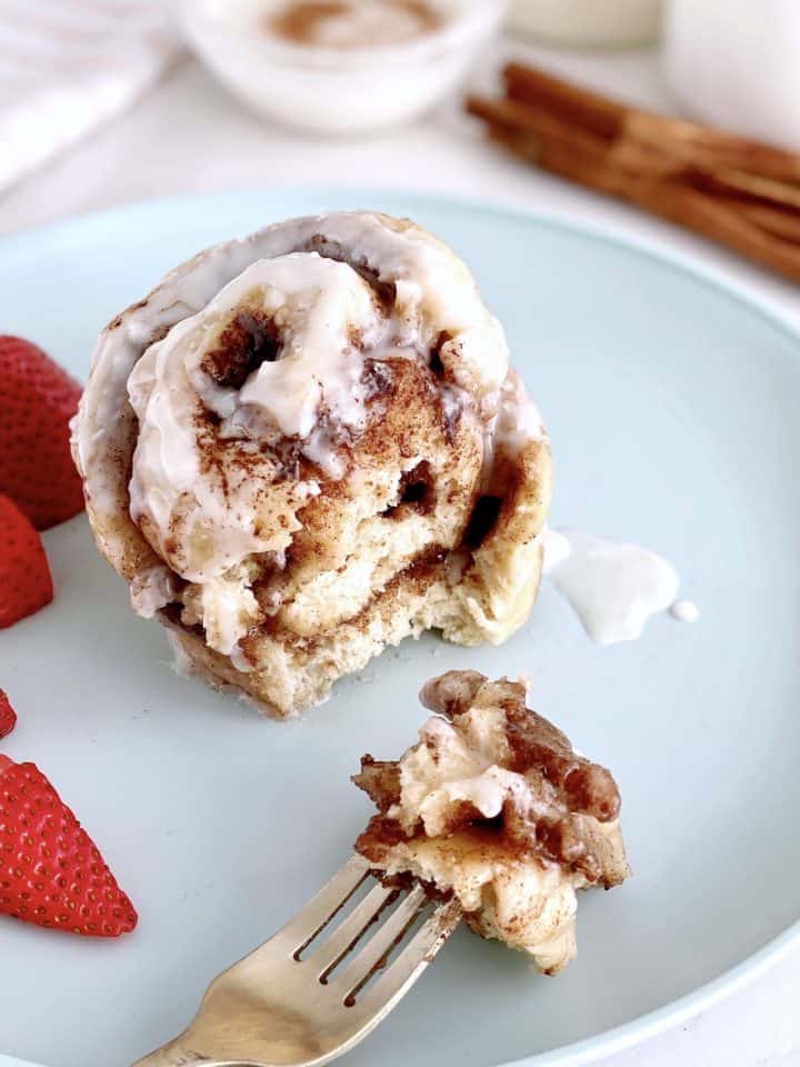 cinnamon roll on a plate with fork