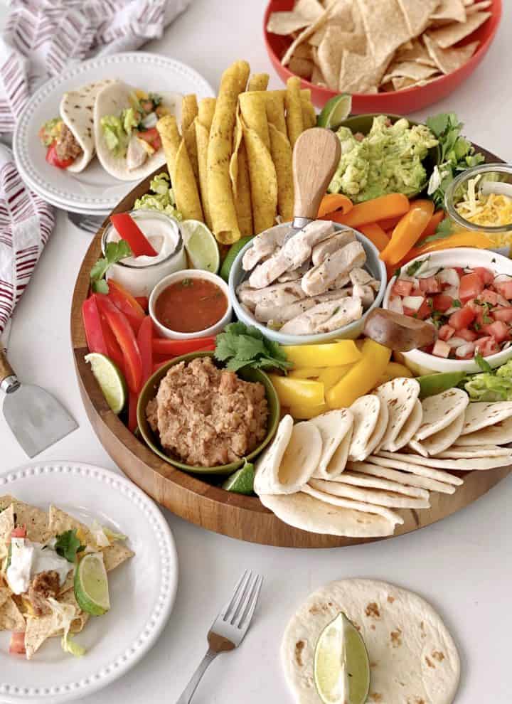 Mexican Buffet Board with plates around 