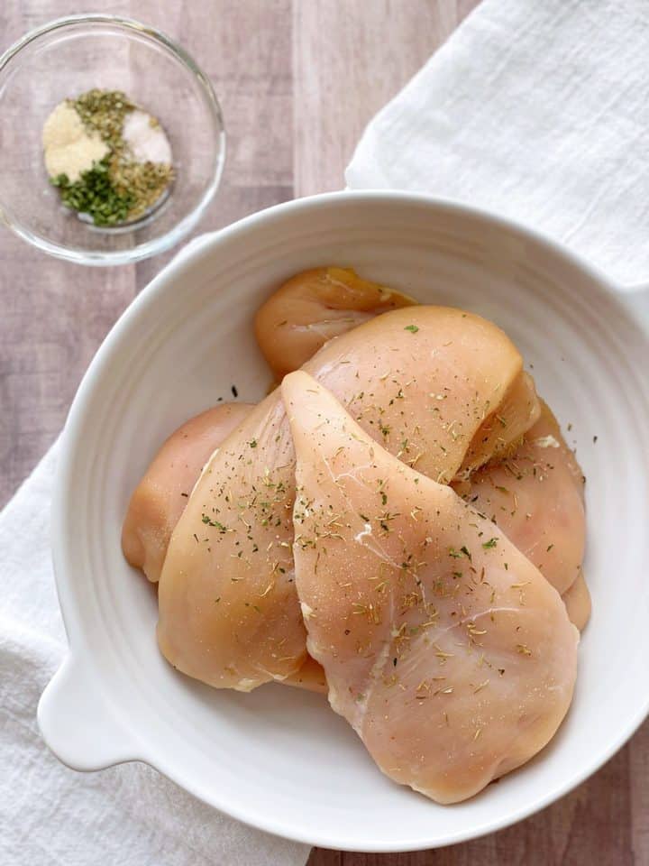 raw chicken with seasoning in a bowl 