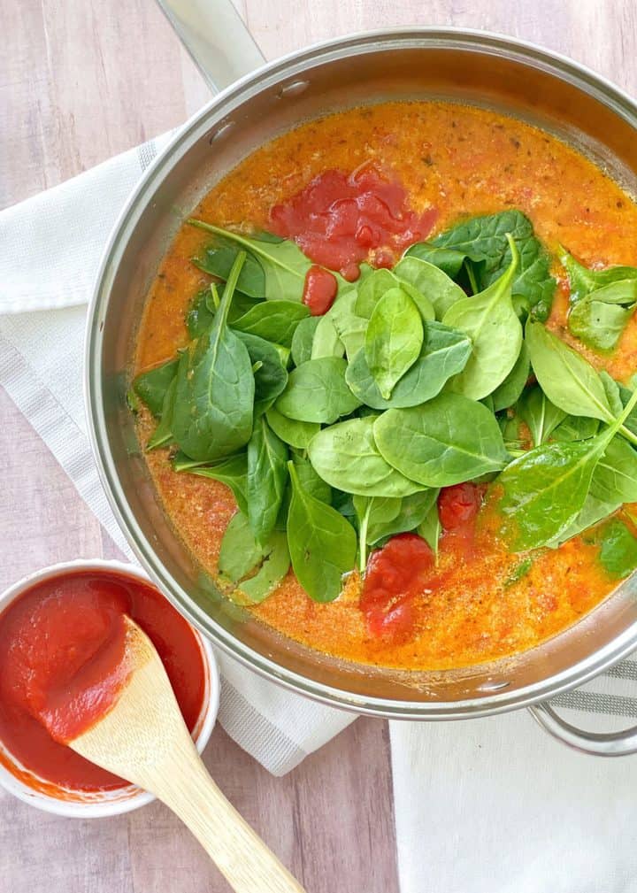 pan with spinach and tomato sauce