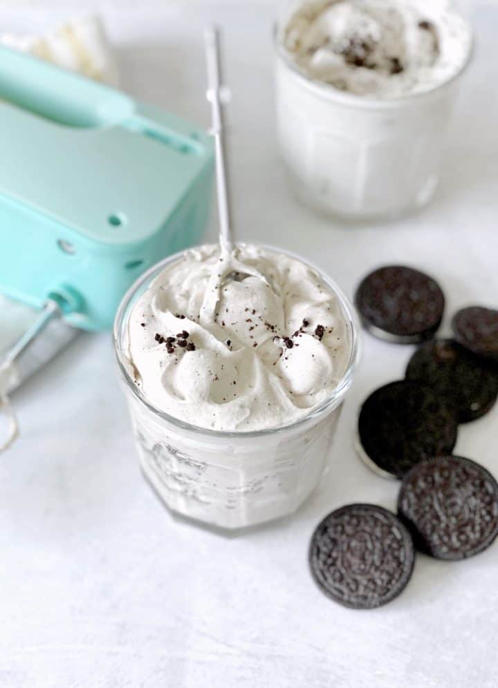 cup with oreo fluff and a beater inserted to show thickness