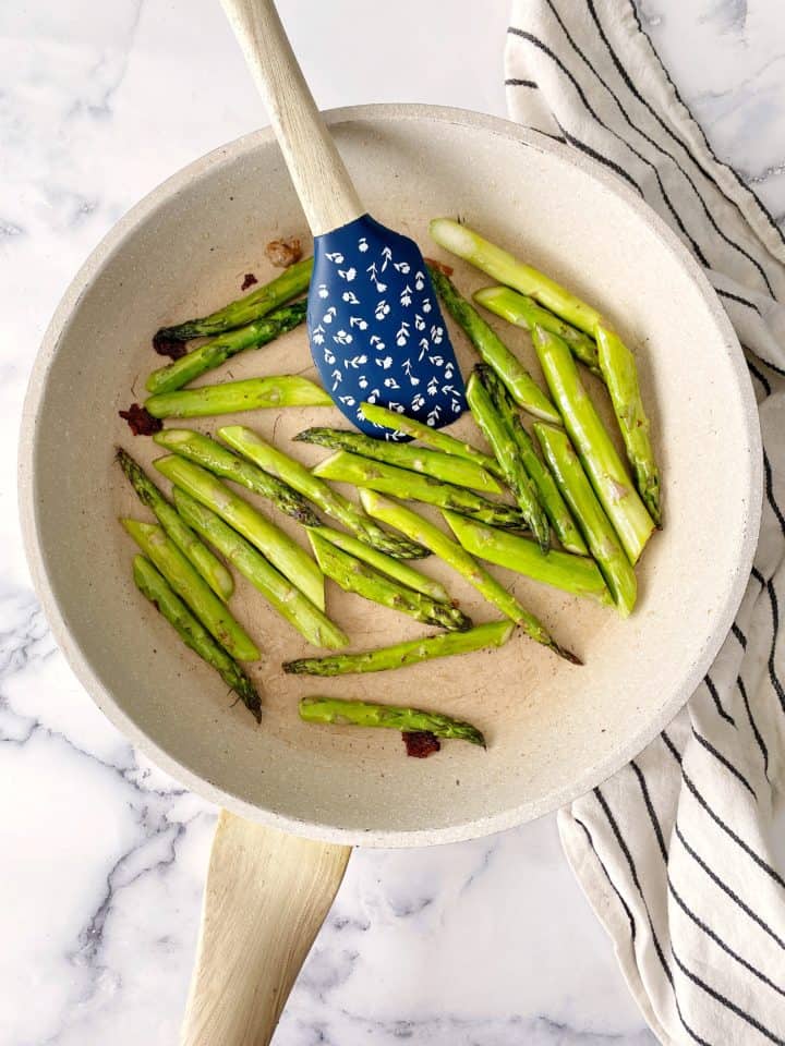 pan with asparagus and a spatula 