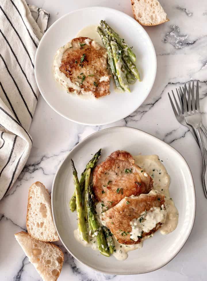 two plates of pork chops with asparagus for thin pork chop recipe