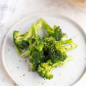 close up of cooked broccoli on a plaste