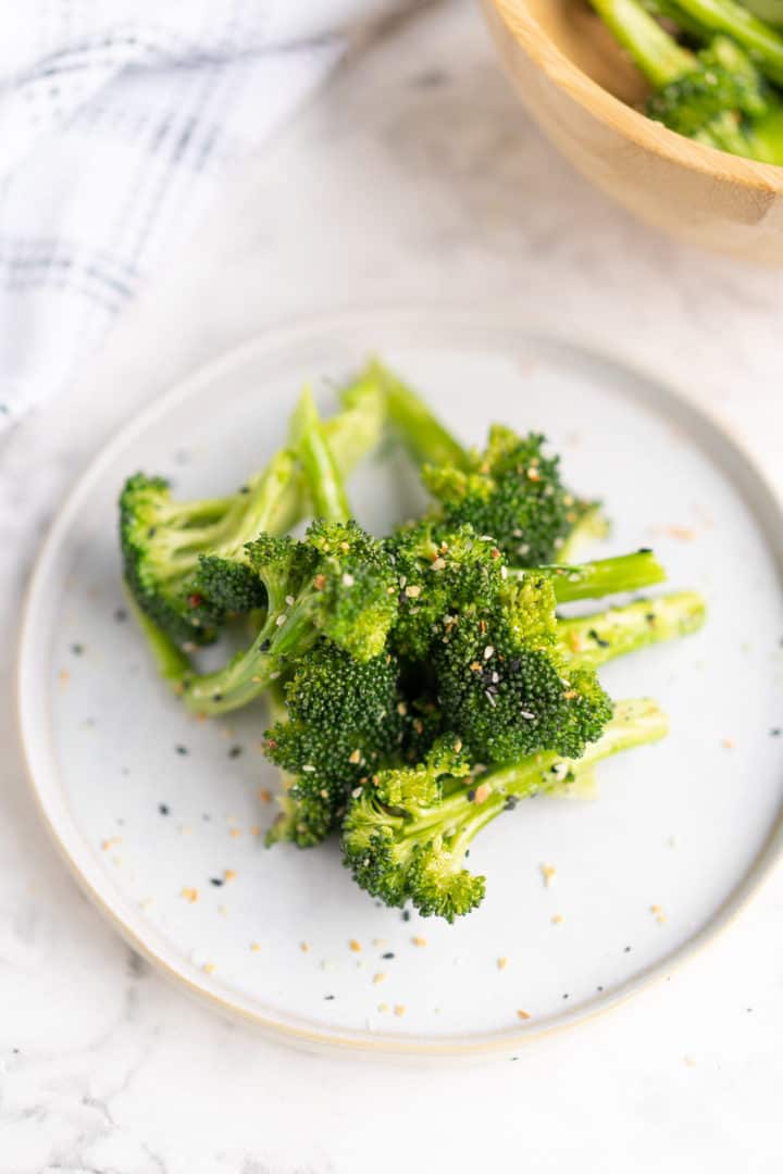 close up of cooked broccoli on a plaste 
