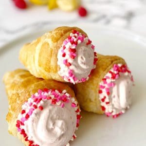 three cream horns on top of a plate