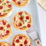 close up of mini pizzas in a baking dish