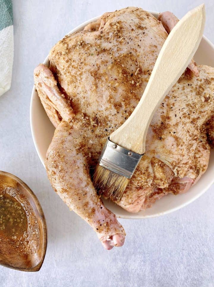 chicken with seasonings and brush