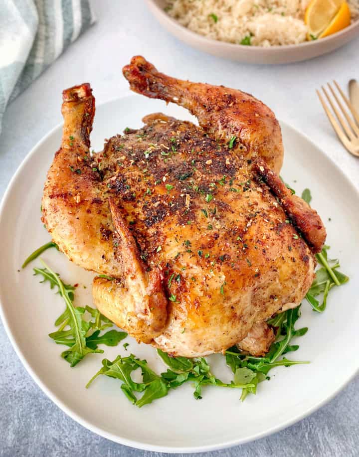 whole air fryer chicken on a plate